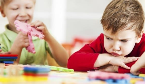 Frustrated Child playing with toys